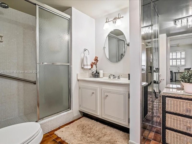 full bath with a shower stall, toilet, vanity, and wood finished floors