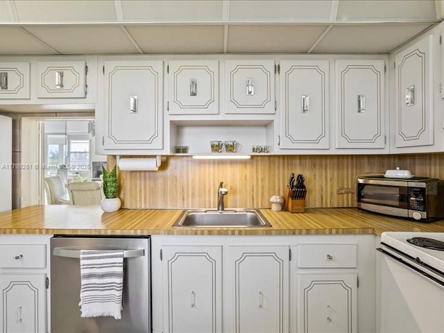 kitchen with stainless steel dishwasher, a sink, and white cabinetry