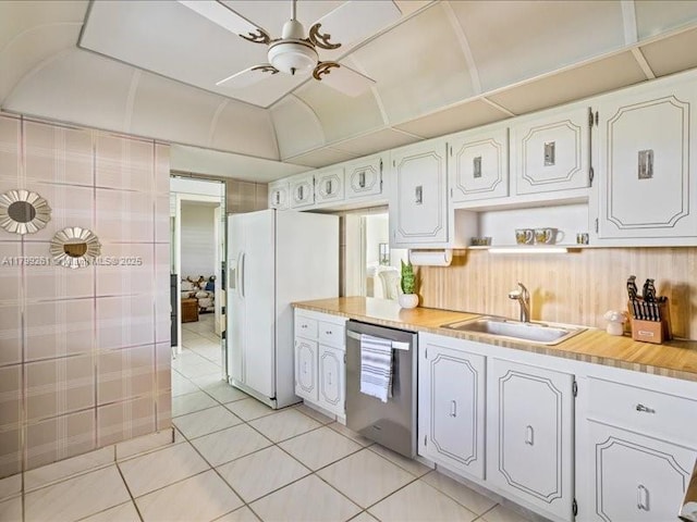 kitchen featuring dishwasher, white refrigerator with ice dispenser, a sink, light tile patterned floors, and light countertops