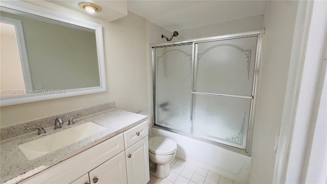 full bathroom with toilet, vanity, shower / bath combination with glass door, and tile patterned floors
