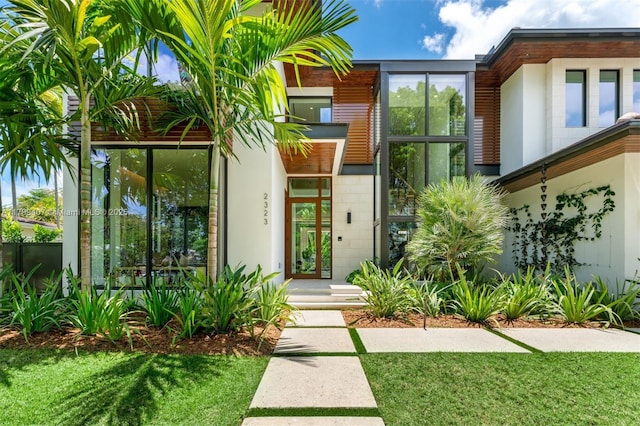 doorway to property featuring a lawn