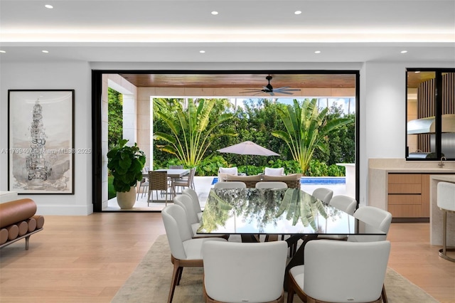 dining area featuring light wood-style flooring, a ceiling fan, and recessed lighting