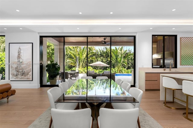dining area featuring healthy amount of natural light, light wood-style floors, a ceiling fan, and recessed lighting