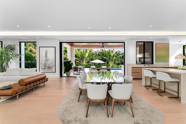 dining area featuring light wood-type flooring, healthy amount of natural light, recessed lighting, and ceiling fan