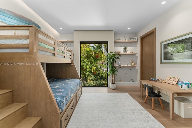bedroom featuring wood finished floors, baseboards, and recessed lighting