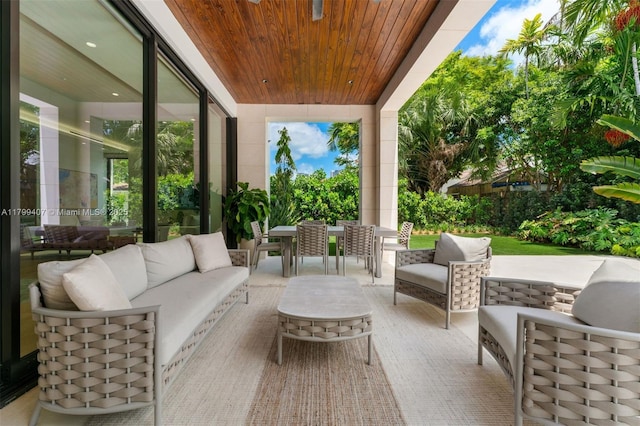 sunroom featuring an outdoor hangout area and outdoor dining space