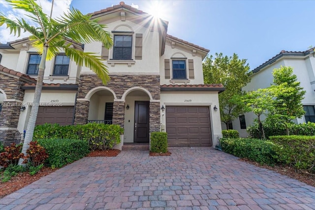25079 SW 114th Ct, Homestead, FL 33032 - view of front of house featuring stucco siding, a garage, decorative driveway, stone siding, and a tile roof