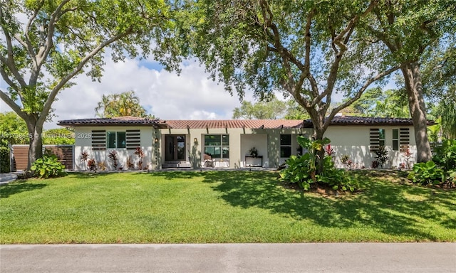 17514 SW 82nd Ct, Palmetto Bay, FL 33157 - view of front of home featuring stucco siding, a front yard, and a tile roof