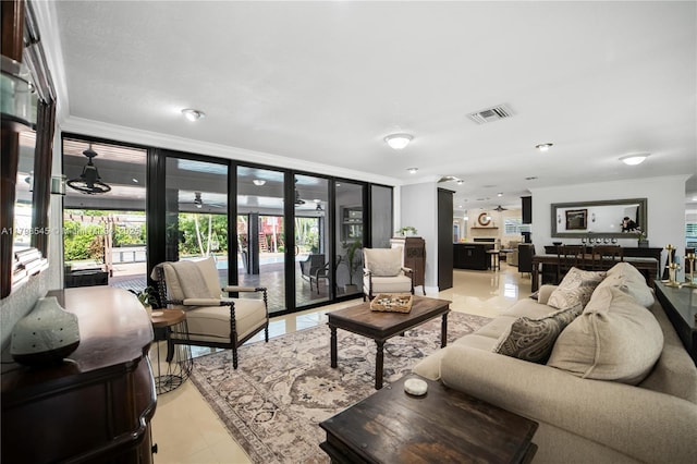 living room with crown molding, french doors, and light tile patterned floors