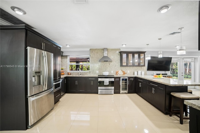 17514 SW 82nd Ct, Palmetto Bay, FL 33157 - kitchen with appliances with stainless steel finishes, beverage cooler, wall chimney exhaust hood, ornamental molding, and a peninsula