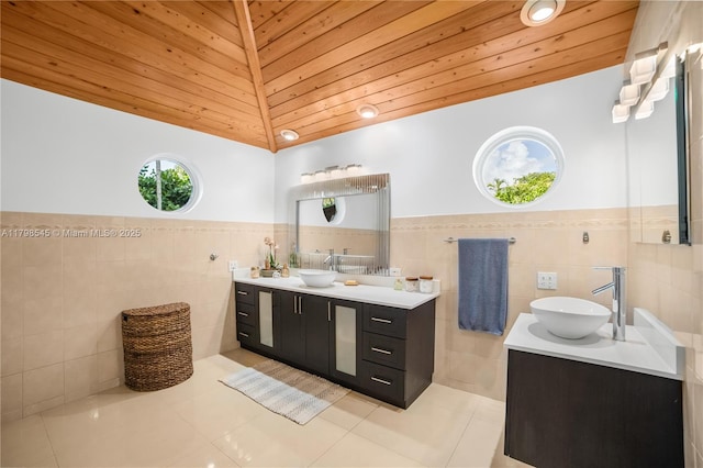 17514 SW 82nd Ct, Palmetto Bay, FL 33157 - bathroom featuring tile walls, double vanity, tile patterned flooring, wainscoting, and wood ceiling