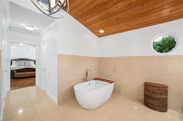 17514 SW 82nd Ct, Palmetto Bay, FL 33157 - ensuite bathroom featuring a freestanding bath, tile walls, tile patterned floors, wooden ceiling, and wainscoting