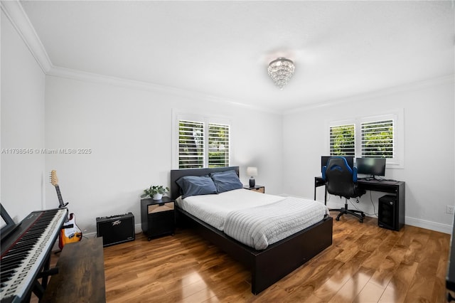 bedroom with crown molding, multiple windows, wood finished floors, and an office area
