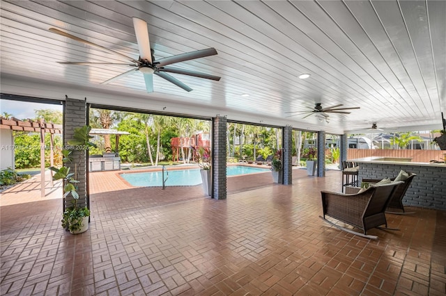 view of patio / terrace featuring ceiling fan, an outdoor pool, and fence