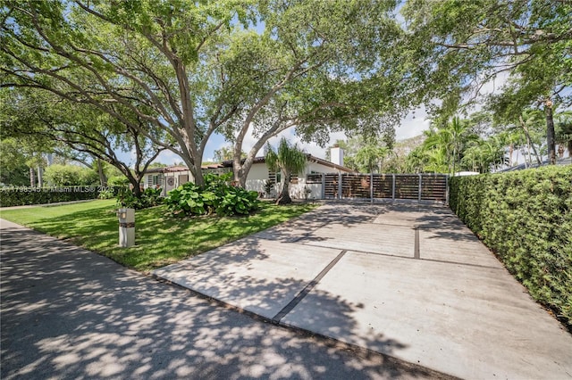 17514 SW 82nd Ct, Palmetto Bay, FL 33157 - view of front facade with driveway and a gate