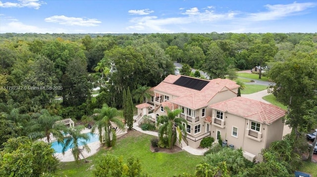 12 Tidewater Dr, Ormond Beach, FL 32174 - aerial view of property and surrounding area featuring a heavily wooded area and a pool area