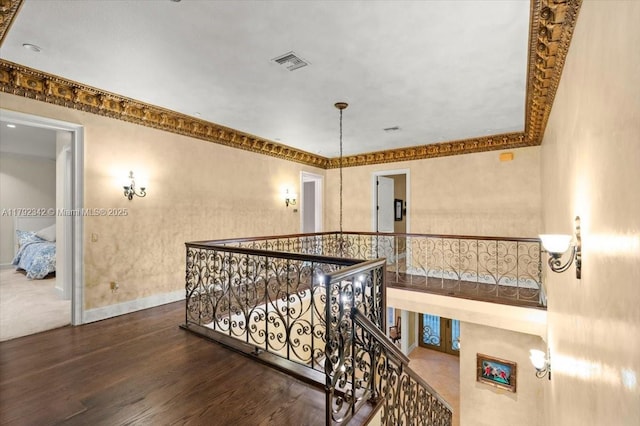 12 Tidewater Dr, Ormond Beach, FL 32174 - hallway with an upstairs landing, dark wood-style flooring, baseboards, and crown molding