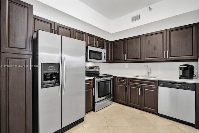 3400 NE 192nd St Unit Ph11, Aventura, FL 33180 - kitchen featuring appliances with stainless steel finishes, a sink, light countertops, and dark brown cabinetry