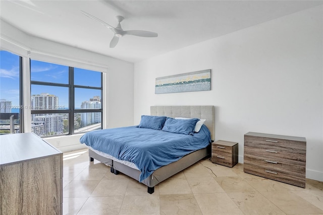 3400 NE 192nd St Unit Ph11, Aventura, FL 33180 - bedroom featuring a view of city, a ceiling fan, and baseboards