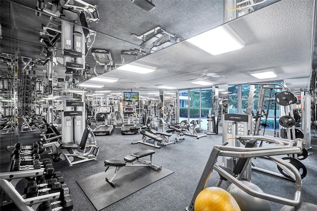 3400 NE 192nd St Unit Ph11, Aventura, FL 33180 - exercise room featuring a textured ceiling, a wall of windows, and ceiling fan