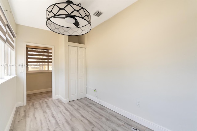 327 S 28th Ave, Hollywood, FL 33020 - unfurnished bedroom featuring wood finished floors, a closet, and baseboards