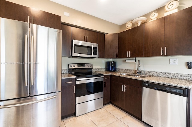 327 S 28th Ave, Hollywood, FL 33020 - kitchen with stainless steel appliances, a sink, light tile patterned floors, and dark brown cabinets