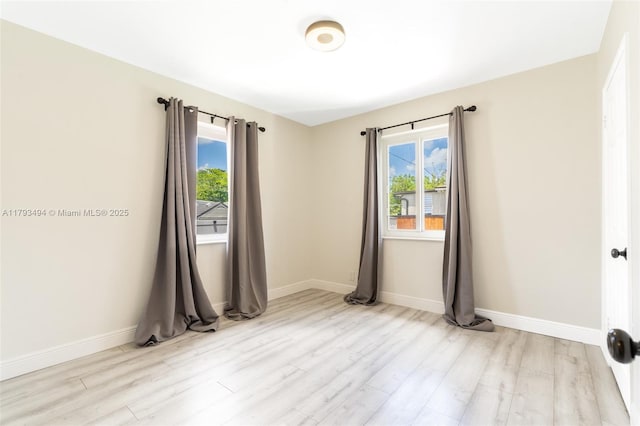 327 S 28th Ave, Hollywood, FL 33020 - unfurnished room with wood finished floors, healthy amount of natural light, and baseboards