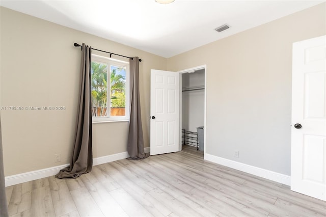 327 S 28th Ave, Hollywood, FL 33020 - unfurnished bedroom with light wood finished floors, baseboards, and a closet