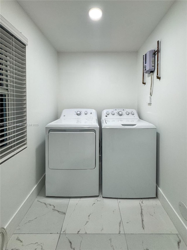 2966 NW 26th St, Miami, FL 33142 - laundry room featuring marble finish flooring, washer and dryer, and baseboards