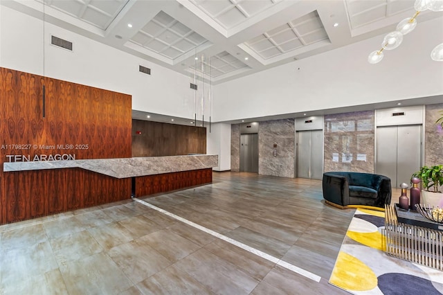 10 Aragon Ave Unit 1107, Coral Gables, FL 33134 - community lobby featuring a towering ceiling, coffered ceiling, and beam ceiling