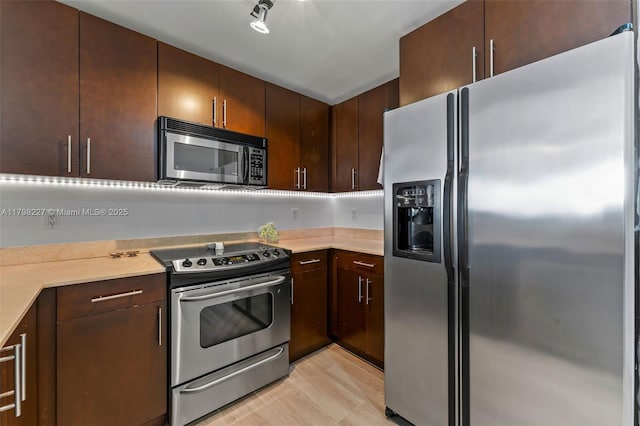 10 Aragon Ave Unit 1107, Coral Gables, FL 33134 - kitchen with appliances with stainless steel finishes, light countertops, and dark brown cabinetry