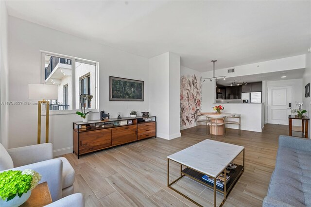 10 Aragon Ave Unit 1107, Coral Gables, FL 33134 - living room with light wood finished floors and baseboards