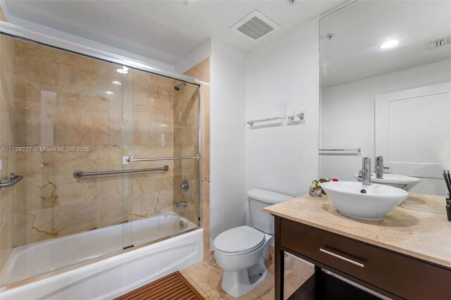 10 Aragon Ave Unit 1107, Coral Gables, FL 33134 - bathroom featuring toilet, shower / bath combination with glass door, and vanity