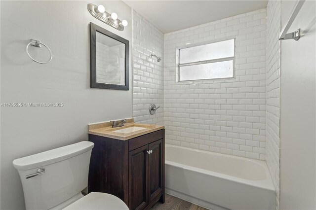 bathroom featuring shower / washtub combination, toilet, vanity, and wood finished floors