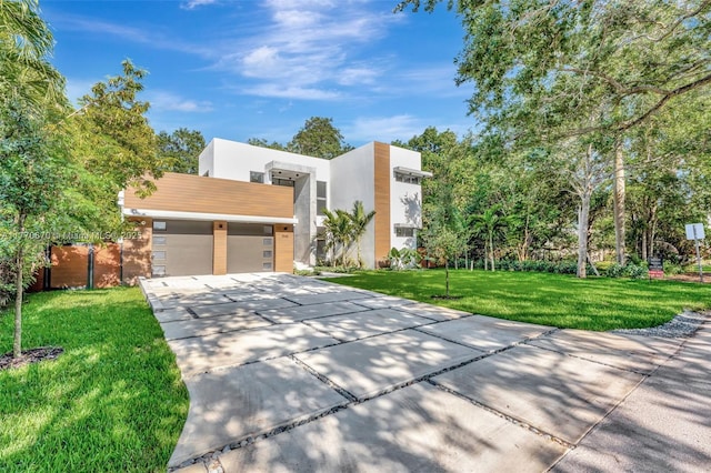 11143 NE 8th Ave, Biscayne Park, FL 33161 - modern home with a garage, driveway, a front yard, and stucco siding