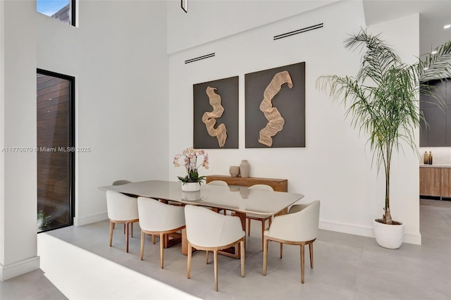 11143 NE 8th Ave, Biscayne Park, FL 33161 - dining space featuring baseboards and a high ceiling