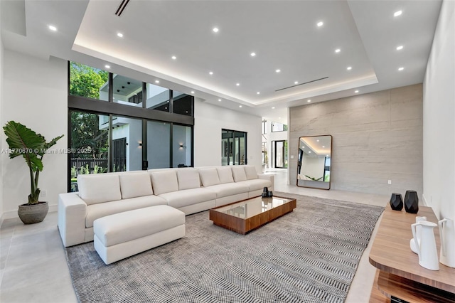 11143 NE 8th Ave, Biscayne Park, FL 33161 - living room featuring a tray ceiling, recessed lighting, a high ceiling, and an accent wall