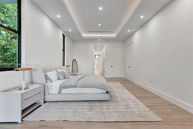 11143 NE 8th Ave, Biscayne Park, FL 33161 - bedroom with light wood finished floors, recessed lighting, and a raised ceiling