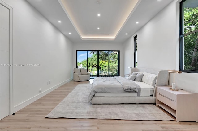 11143 NE 8th Ave, Biscayne Park, FL 33161 - bedroom featuring light wood-type flooring, recessed lighting, a raised ceiling, and baseboards