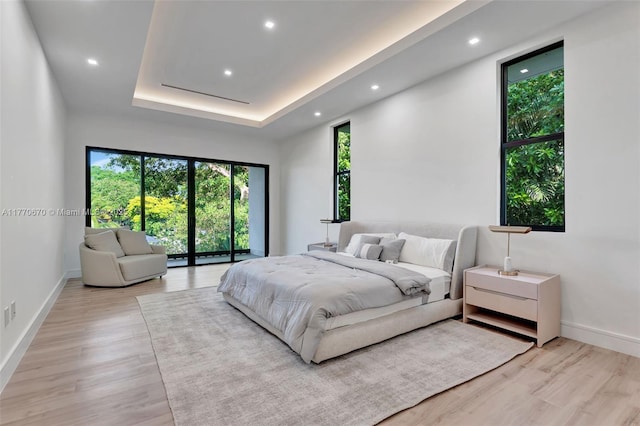 11143 NE 8th Ave, Biscayne Park, FL 33161 - bedroom with light wood-style floors, recessed lighting, and a raised ceiling