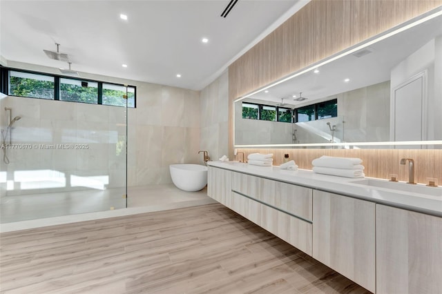 11143 NE 8th Ave, Biscayne Park, FL 33161 - full bathroom with a walk in shower, a soaking tub, double vanity, and wood finished floors