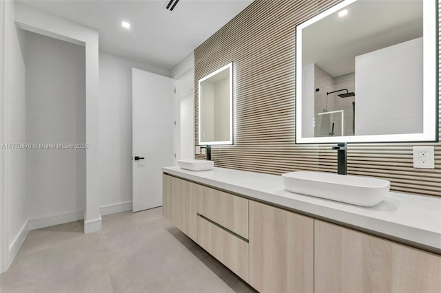 11143 NE 8th Ave, Biscayne Park, FL 33161 - bathroom with a tile shower, baseboards, double vanity, and recessed lighting