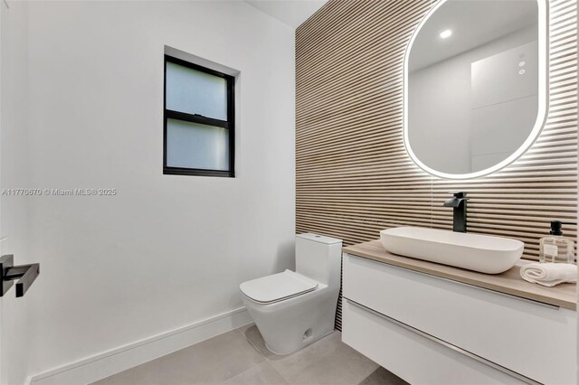 11143 NE 8th Ave, Biscayne Park, FL 33161 - bathroom with tile patterned flooring, toilet, baseboards, and vanity