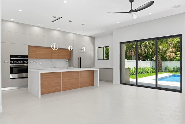 1320 NE 16th Ave, Fort Lauderdale, FL 33304 - kitchen featuring modern cabinets, a ceiling fan, a sink, light countertops, and recessed lighting