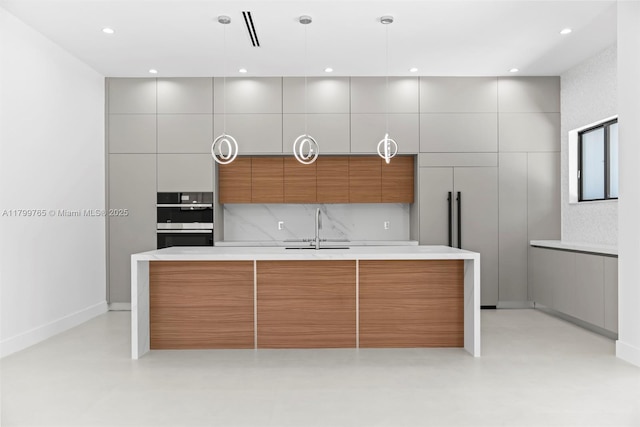 1320 NE 16th Ave, Fort Lauderdale, FL 33304 - kitchen featuring modern cabinets, a sink, double oven, light countertops, and concrete flooring