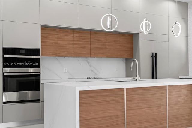 1320 NE 16th Ave, Fort Lauderdale, FL 33304 - kitchen featuring stainless steel oven, brown cabinets, modern cabinets, backsplash, and a sink