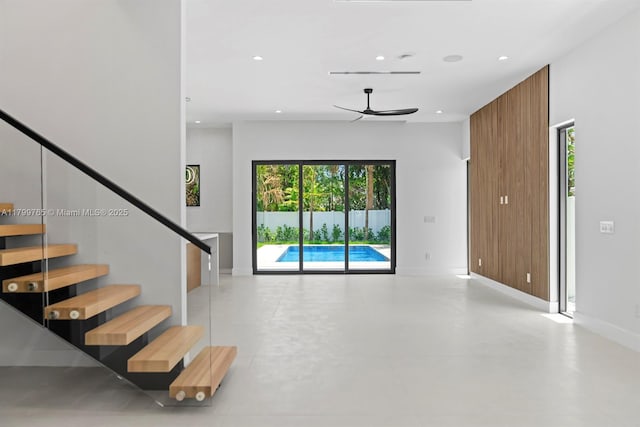 1320 NE 16th Ave, Fort Lauderdale, FL 33304 - unfurnished living room with ceiling fan, recessed lighting, baseboards, stairs, and concrete floors