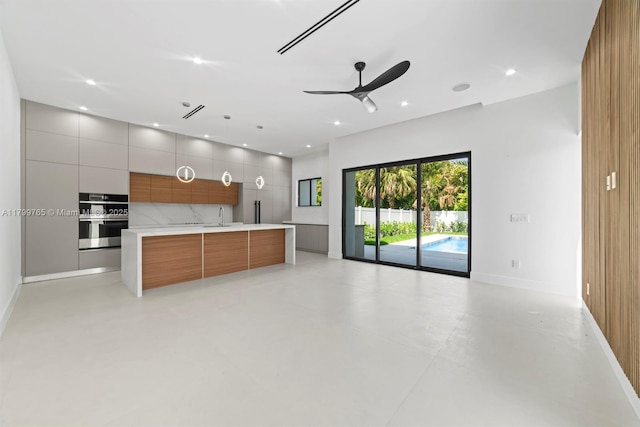 1320 NE 16th Ave, Fort Lauderdale, FL 33304 - kitchen featuring modern cabinets, stainless steel double oven, open floor plan, light countertops, and ceiling fan