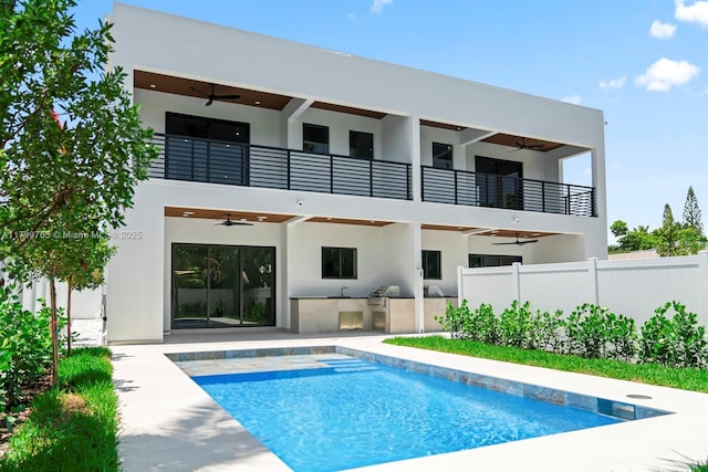 1320 NE 16th Ave, Fort Lauderdale, FL 33304 - back of property with ceiling fan, a balcony, area for grilling, stucco siding, and fence