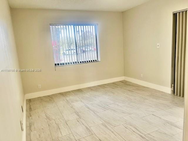 9920 NW 68th Pl Unit 103, Tamarac, FL 33321 - empty room with baseboards
